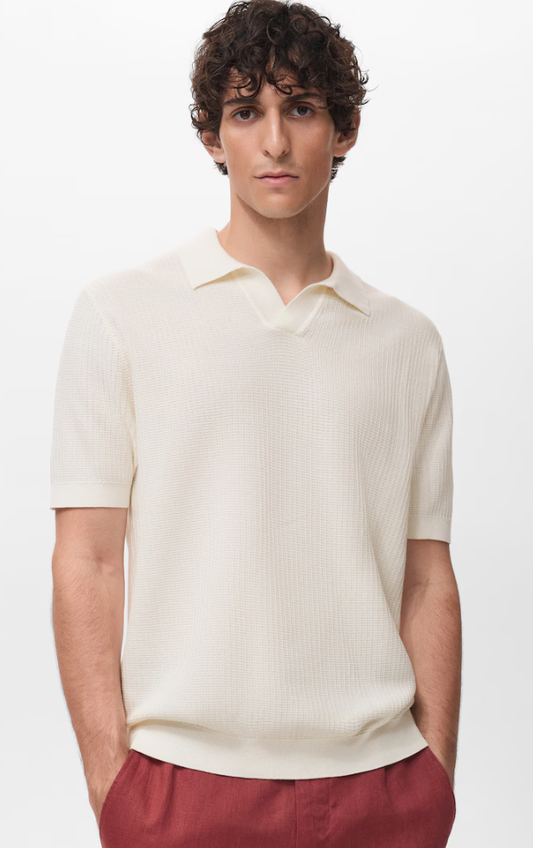 Man wearing a cream-colored polo shirt and red pants on a white background